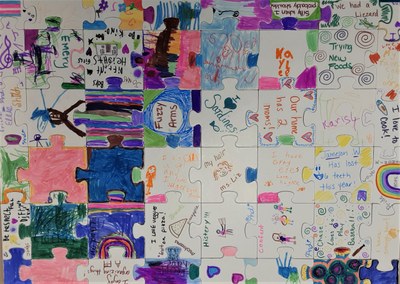 Puzzle made of pieces colored by children listing what they think is different about themselves