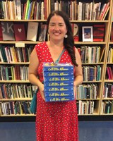 Colby Cedar Smith holding copies of her book
